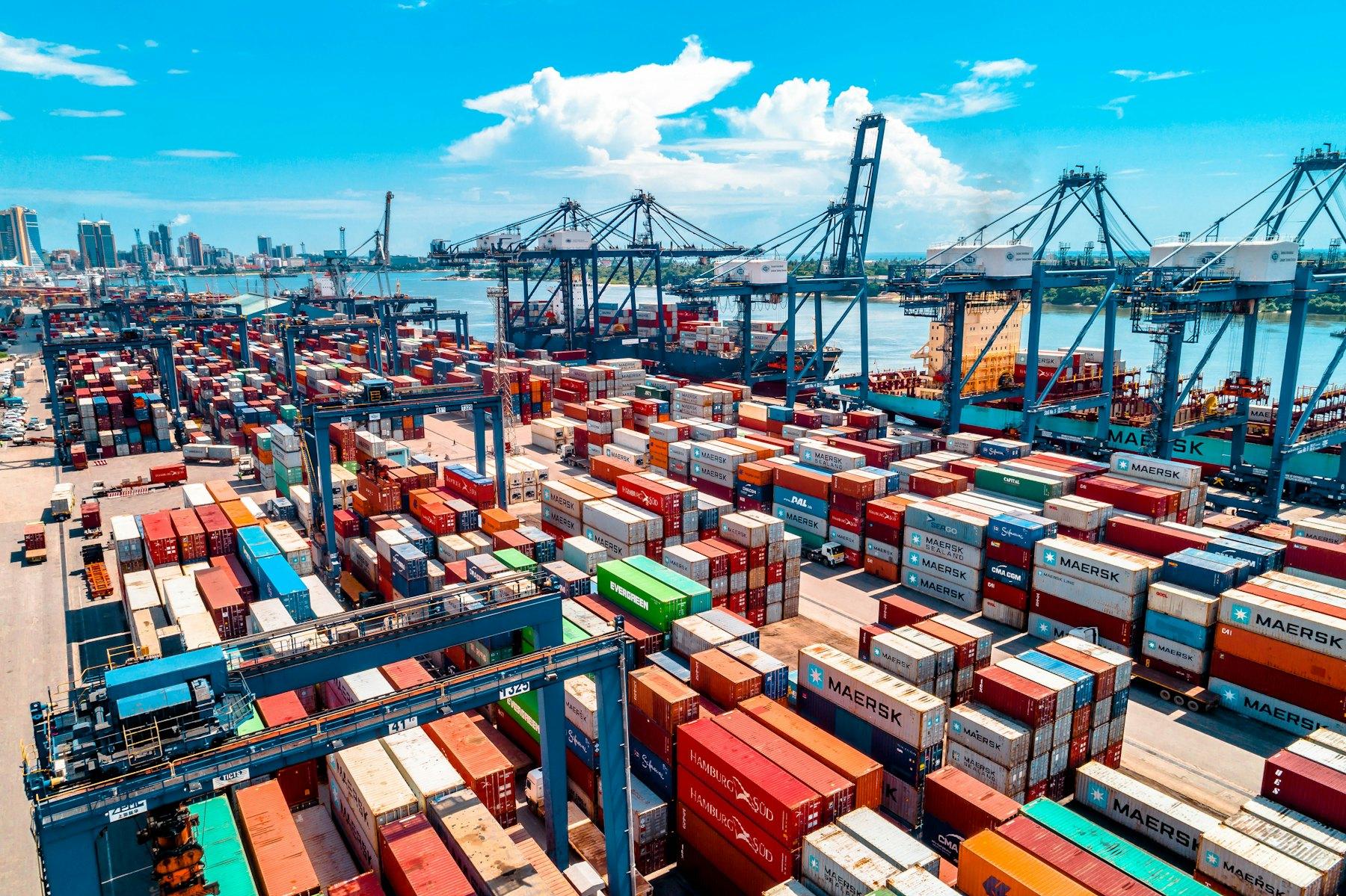 Aerial view of shipping containers stacked at a working port