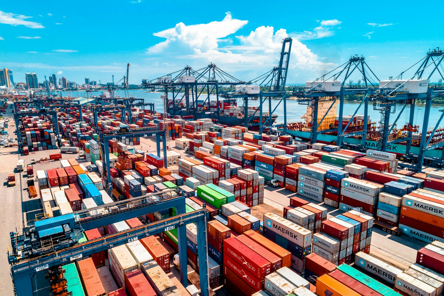 Aerial view of shipping containers stacked at a working port